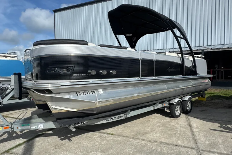 The Image of 2020 Avalon Catalina Platinum Entertainer 25' pontoon boat on trailer, parked outdoors. - 0