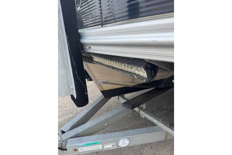 Slide: The Image of 2020 Avalon Catalina Platinum Entertainer boat on trailer, showcasing undercarriage details. - 13