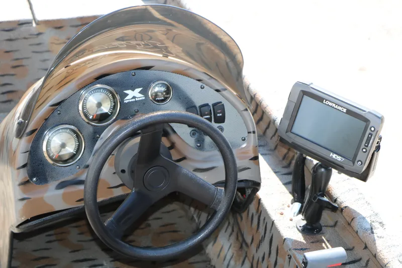 Slide: The Image of 2015 Xpress XP170 boat dashboard with steering wheel and Lowrance HDS7 fishfinder. - 16