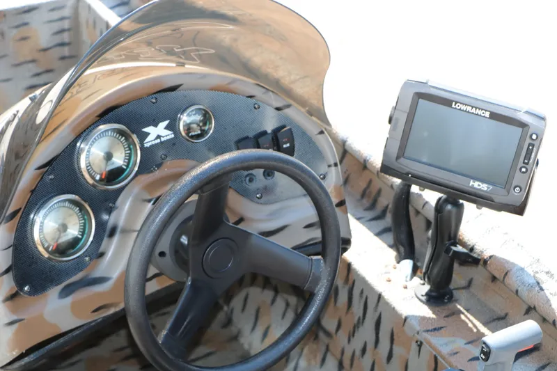 Slide: The Image of 2015 Xpress XP170 boat dashboard with steering wheel and Lowrance HDS7 fishfinder. - 26