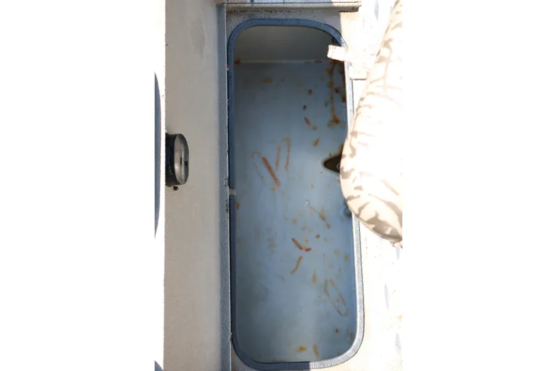 Slide: The Image of Open storage compartment in 2015 Xpress XP170 boat, showing interior details. - 28