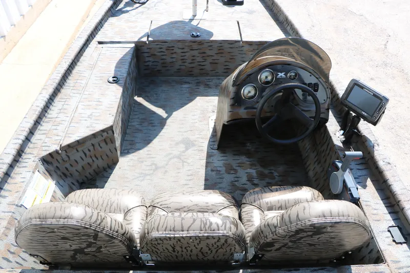 Slide: The Image of 2015 Xpress XP170 boat interior with steering wheel, seats, and control panel. - 15
