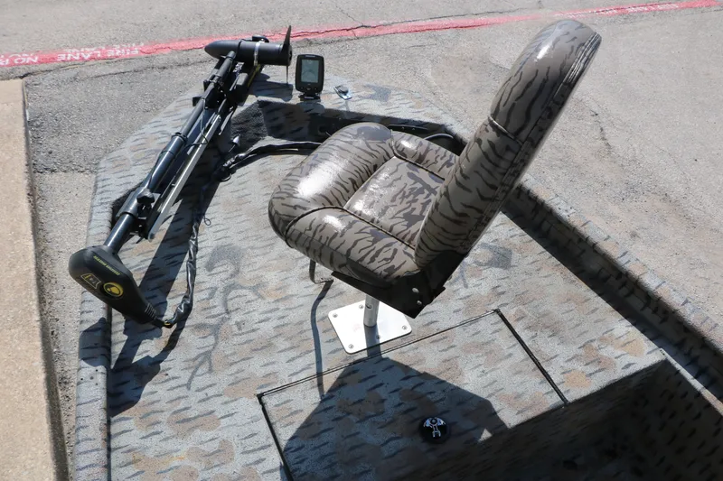 Slide: The Image of 2015 Xpress XP170 boat interior with camo seat and trolling motor. - 18