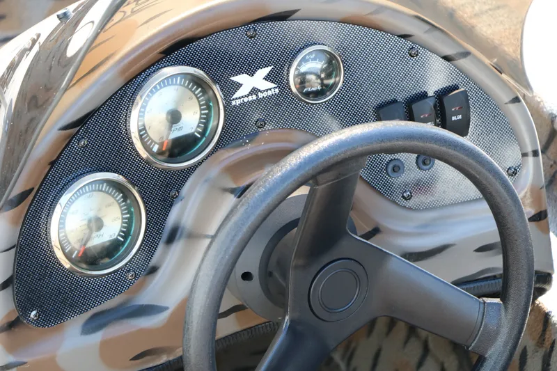 Slide: The Image of Dashboard of a 2015 Xpress XP170 boat with gauges and steering wheel. - 27