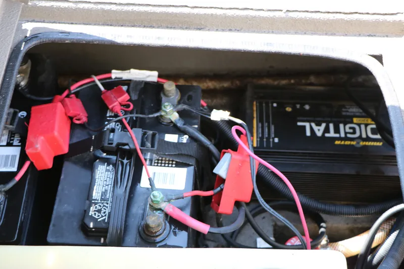 Slide: The Image of Battery compartment of a 2015 Xpress XP170 boat with visible wiring and connections. - 29