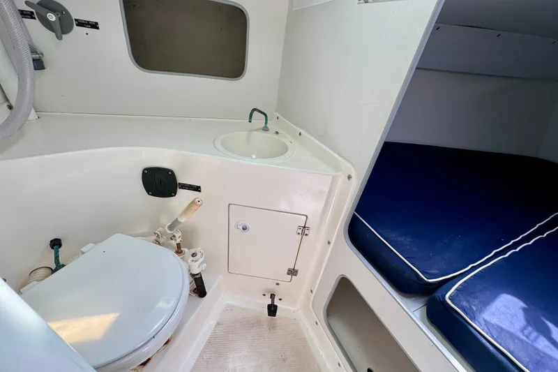 Slide: The Image of Interior of 2000 J Boats J/105 featuring compact marine toilet and cozy sleeping berth. - 16