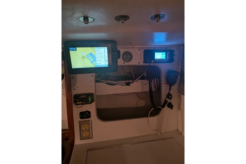 Slide: The Image of Navigation equipment inside a 2000 J Boats J/105 sailboat, featuring modern electronics and controls. - 15