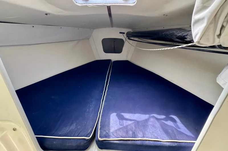 Slide: The Image of Interior cabin of 2000 J Boats J/105 sailboat with blue cushions. - 14