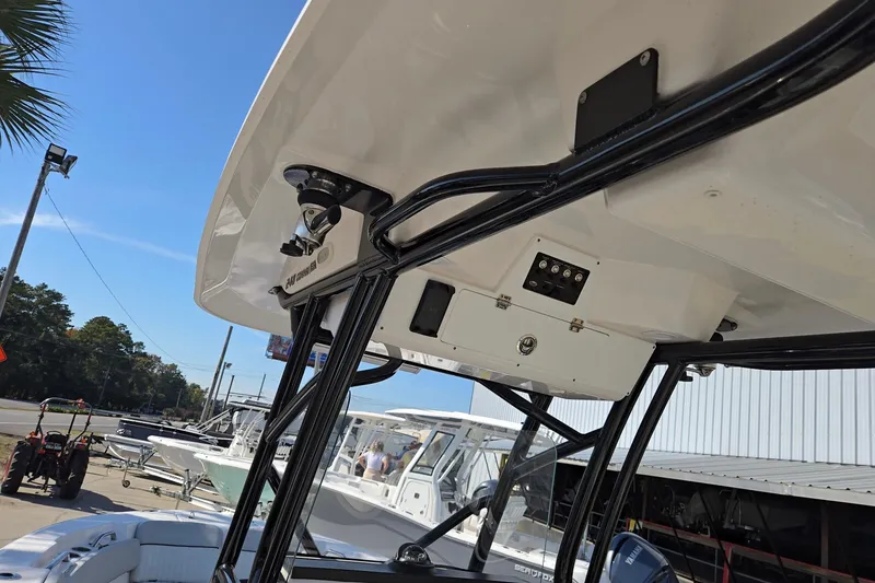 Slide: The Image of 2023 Sea Fox 248 Commander boat with T-top and console, docked outdoors. - 30