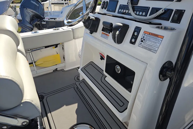 Slide: The Image of 2023 Sea Fox 248 Commander boat interior with control panel and Yamaha engine. - 28