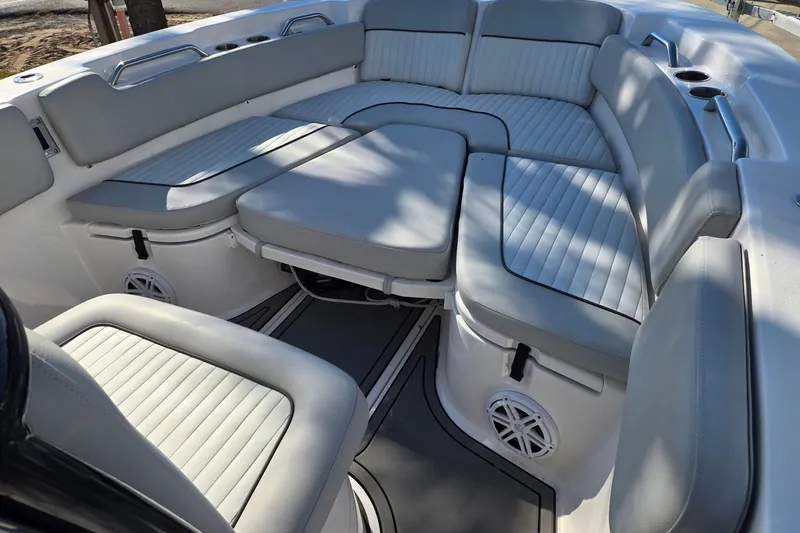 Slide: The Image of 2023 Sea Fox 248 Commander boat interior with cushioned seating and cup holders. - 24