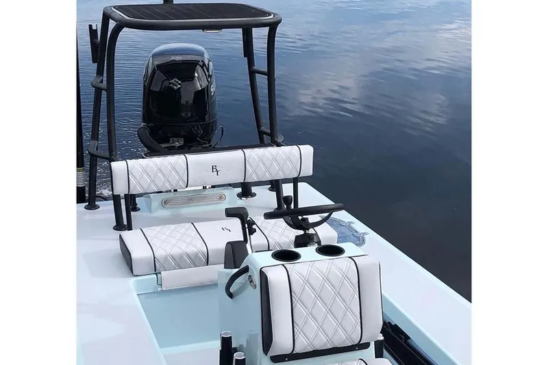 Slide: The Image of Manufacturer Provided Image: 2024 Beavertail Skiffs Strike boat interior with white seating and black accents on calm water. - 14