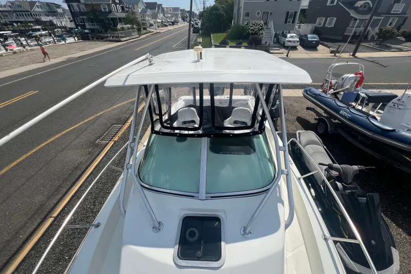 Slide: The Image of 2000 Hydra-Sports 230 Seahorse WA boat parked near a coastal road. - 14