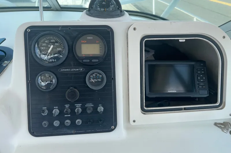 Slide: The Image of Dashboard of a 2000 Hydra-Sports 230 Seahorse WA with gauges and Garmin device. - 18