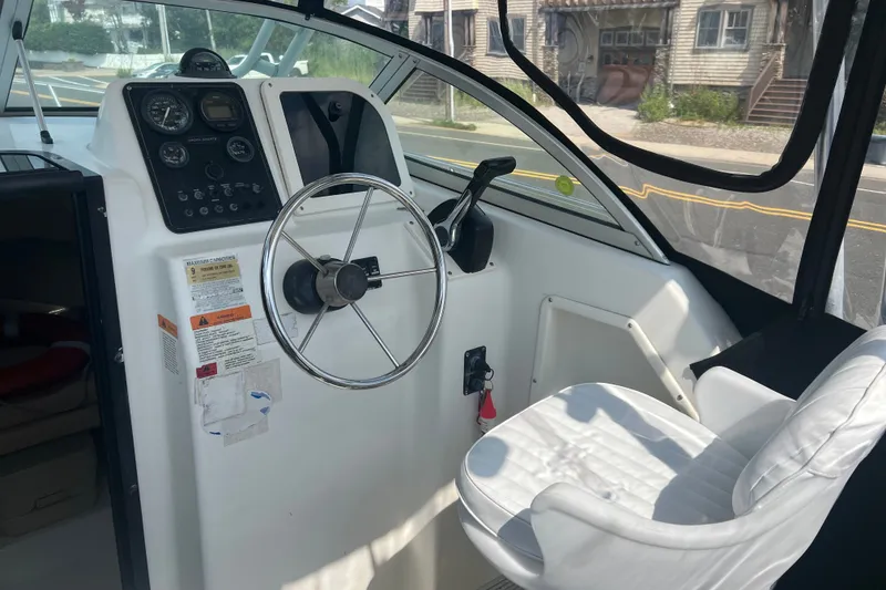 Slide: The Image of Interior view of 2000 Hydra-Sports 230 Seahorse WA boat cockpit with steering wheel and controls. - 15