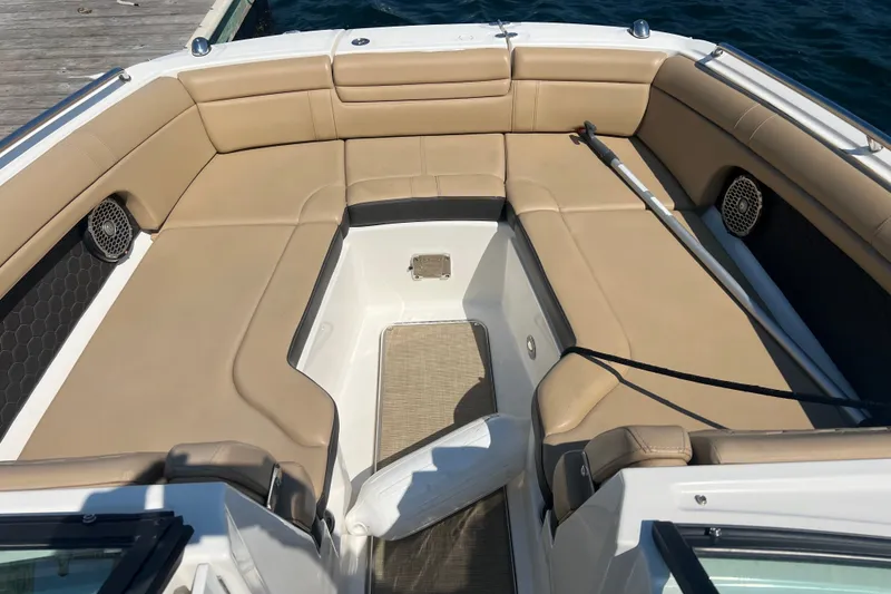 Slide: The Image of 2018 Sea Ray SDX 270 boat interior with tan seating and open deck layout. - 7