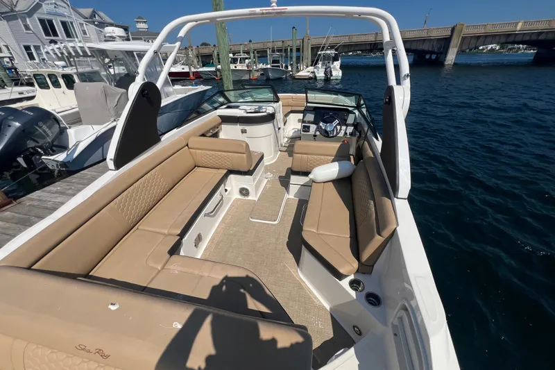Slide: The Image of 2018 Sea Ray SDX 270 boat with tan seating, docked in a marina. - 5