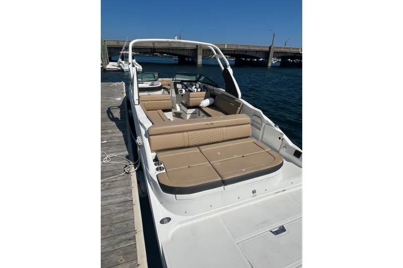 Slide: The Image of 2018 Sea Ray SDX 270 boat docked, featuring spacious seating and sleek design. - 3