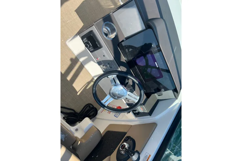Slide: The Image of Cockpit view of 2018 Sea Ray SDX 270 boat with steering wheel and control panel. - 8