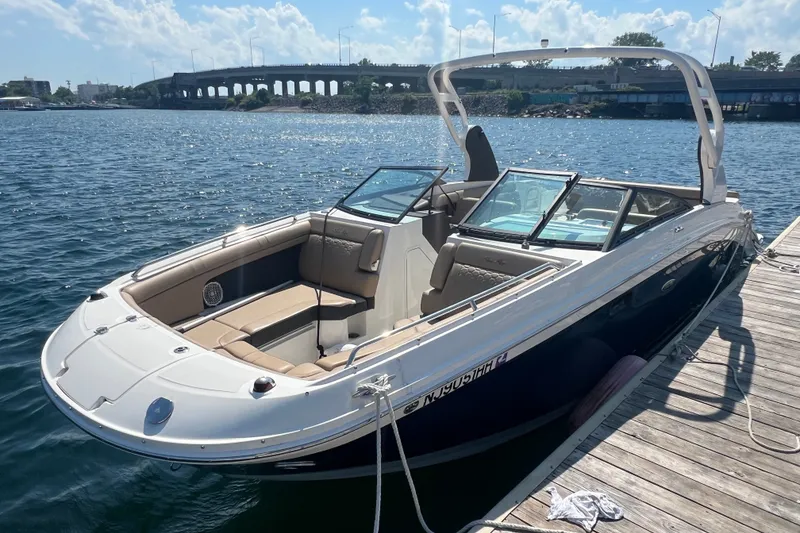 The Image of 2018 Sea Ray SDX 270 boat docked on a sunny day, with bridge in background. - 0
