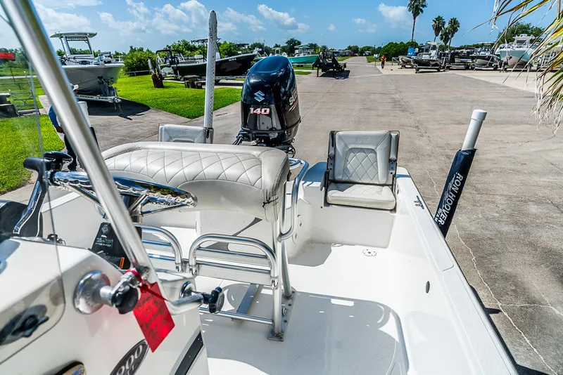 Slide: The Image of A 2018 Blue Wave 1900STL boat with a 140 HP engine, parked on a sunny lot. - 15