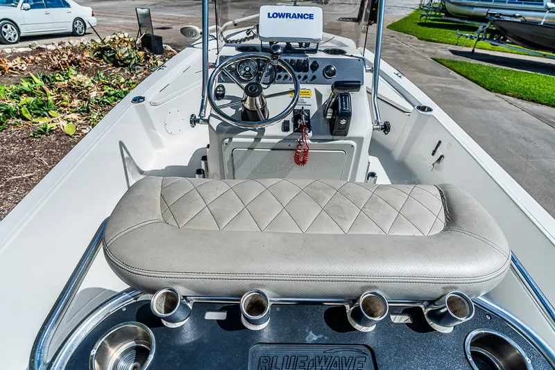 Slide: The Image of The image shows the cockpit of a 2018 Blue Wave 1900STL boat with a helm console and seating. - 12