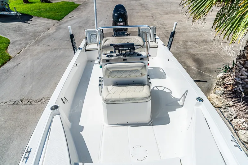 Slide: The Image of The image shows a 2018 Blue Wave 1900STL boat with a central console and cushioned seating. - 17