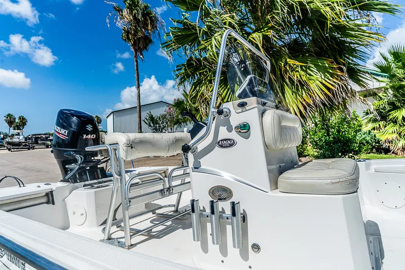 Slide: The Image of A 2018 Blue Wave 1900STL boat with Suzuki engine, surrounded by palm trees and blue sky. - 7