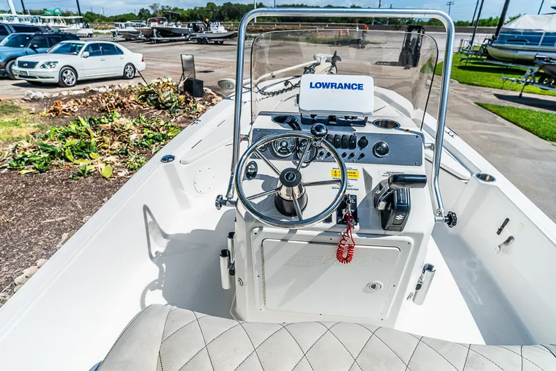 Slide: The Image of The image shows the cockpit of a 2018 Blue Wave 1900STL boat with a helm and Lowrance device. - 13