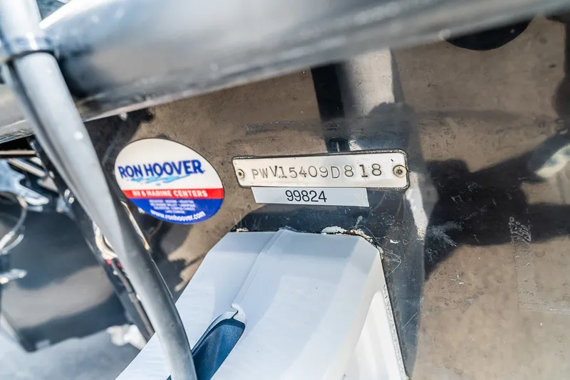 Slide: The Image of Close-up of a boat detail showing a serial number and dealer sticker. - 5