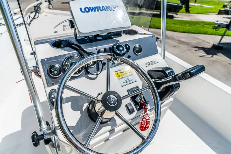 Slide: The Image of The image shows the helm of a 2018 Blue Wave 1900STL boat with a Lowrance Elite GPS. - 14