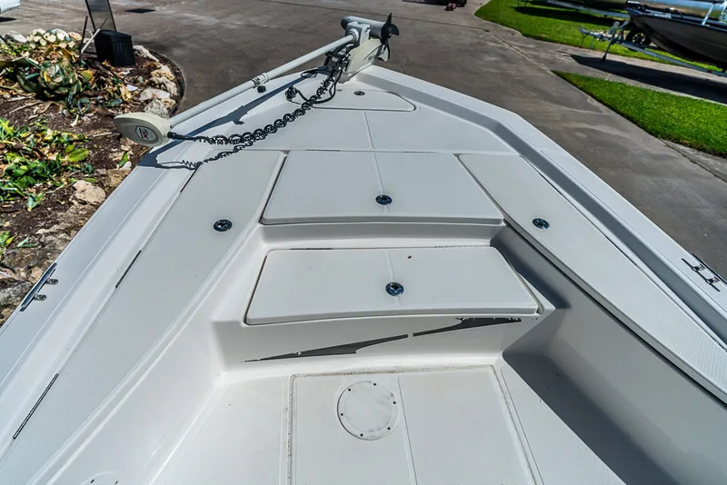Slide: The Image of The image shows the bow deck of a 2018 Blue Wave 1900STL boat with storage compartments. - 16