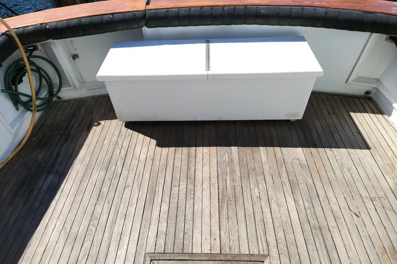 Slide: The Image of 1988 Ocean Yachts 48 Super Sport deck with wooden flooring and storage box. - 14