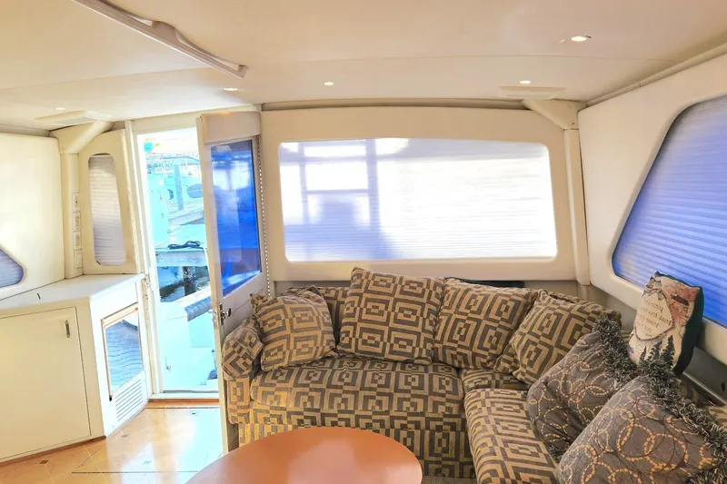 Slide: The Image of Luxurious interior of 1988 Ocean Yachts 48 Super Sport with patterned sofa and natural light. - 34