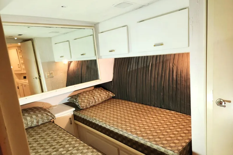 Slide: The Image of 1988 Ocean Yachts 48 Super Sport cabin with twin beds and storage cabinets. - 46