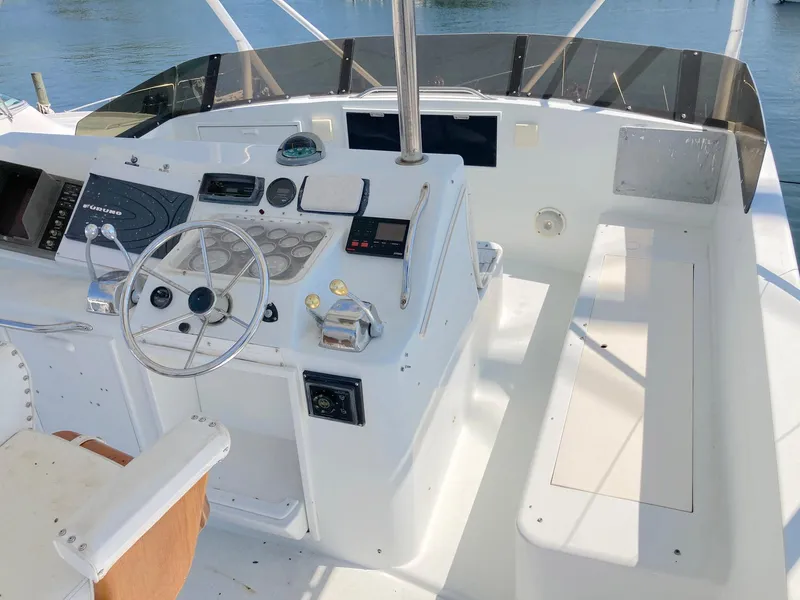 Slide: The Image of Cockpit of 1988 Ocean Yachts 48 Super Sport Convertible with steering wheel and controls. - 19