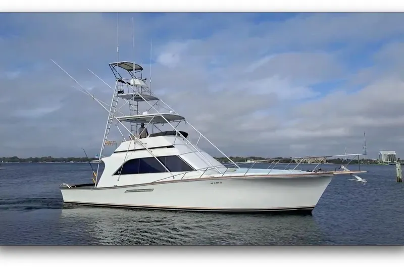 The Image of 1988 Ocean Yachts 48 Super Sport cruising on calm waters under a cloudy sky. - 0