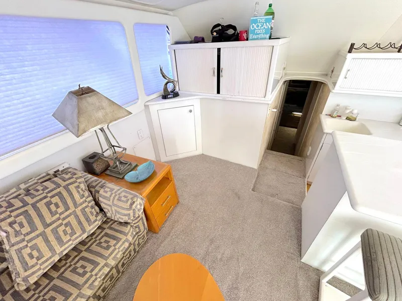 Slide: The Image of Interior of 1988 Ocean Yachts 48 Super Sport Convertible, featuring cozy seating and modern decor. - 31