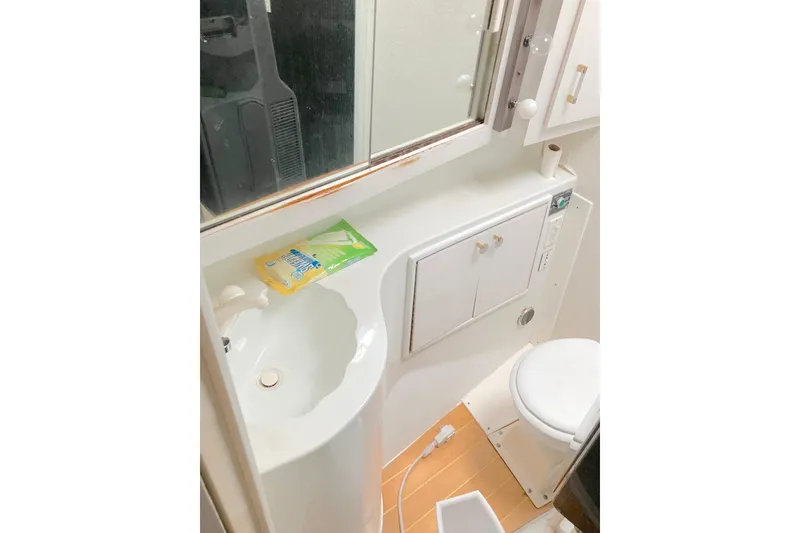 Slide: The Image of Bathroom interior of 1988 Ocean Yachts 48 Super Sport, featuring sink and toilet. - 51