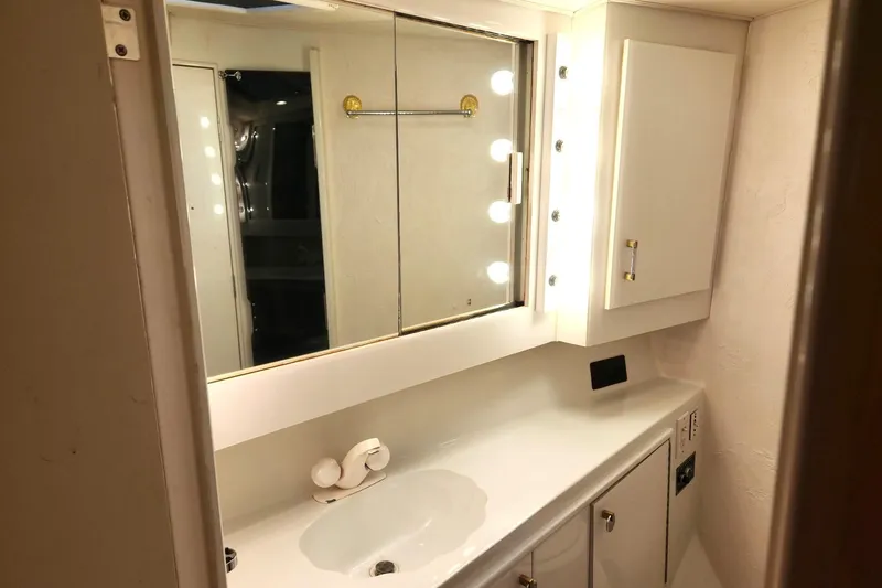Slide: The Image of Bathroom vanity in 1988 Ocean Yachts 48 Super Sport, featuring mirror and lighting. - 45
