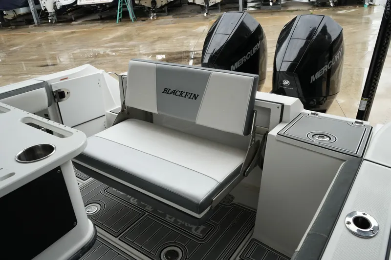 Slide: The Image of 2019 Blackfin 242 CC boat interior with seating and dual Mercury engines. - 26
