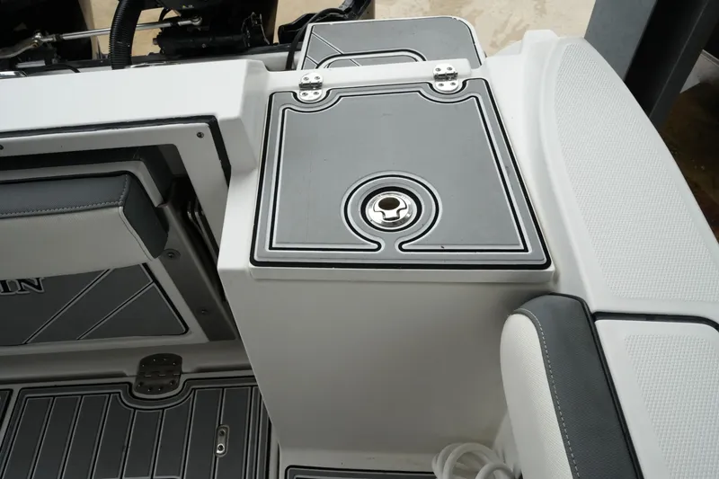 Slide: The Image of 2019 Blackfin 242 CC boat interior with sleek storage compartment and cushioned seating. - 50