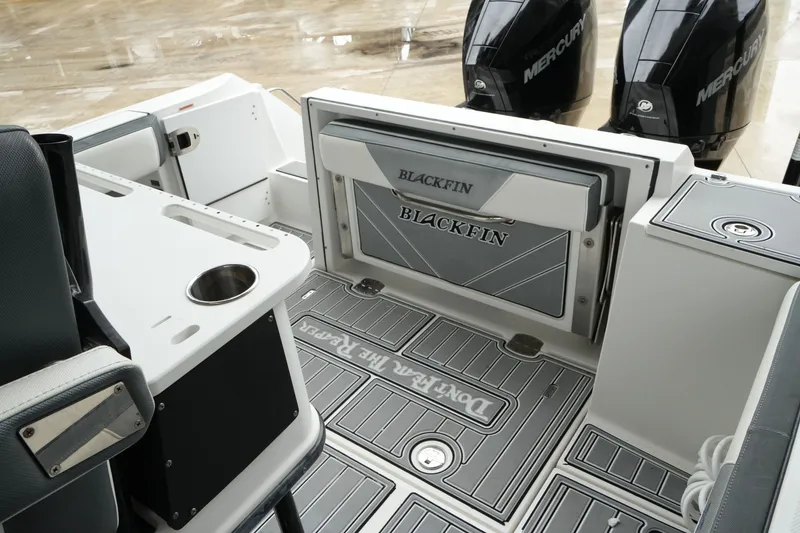 Slide: The Image of 2019 Blackfin 242 CC boat interior with dual Mercury engines and sleek design. - 48
