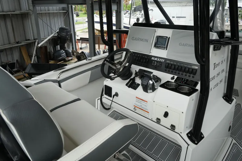 Slide: The Image of 2019 Blackfin 242 CC boat cockpit with Garmin navigation system and steering wheel. - 15