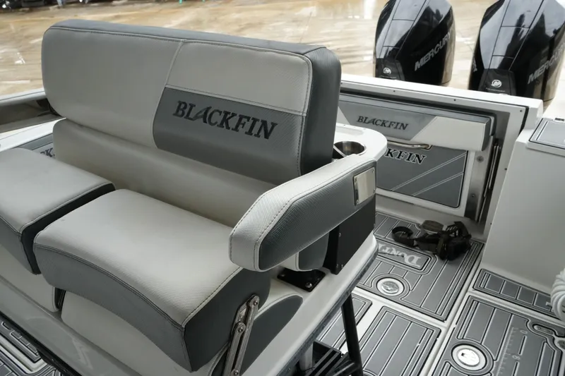 Slide: The Image of 2019 Blackfin 242 CC boat interior with seating and dual Mercury engines. - 47