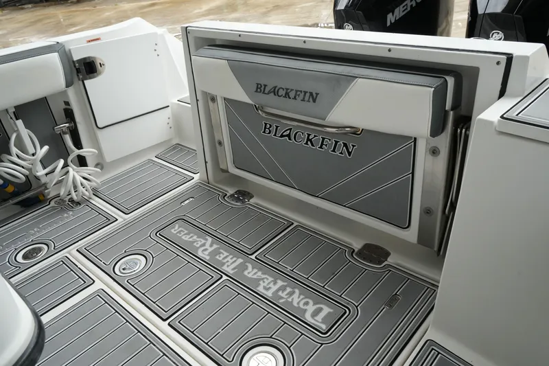 Slide: The Image of 2019 Blackfin 242 CC boat interior with branded flooring and storage compartment. - 24