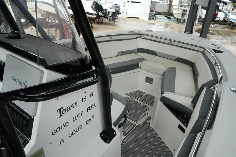 Slide: The Image of 2019 Blackfin 242 CC boat interior with seating and motivational quote. - 55