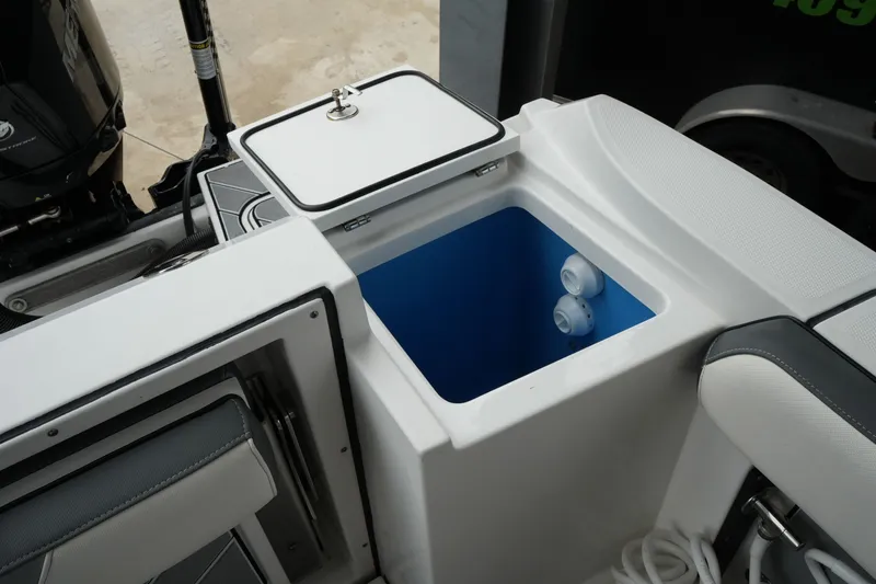 Slide: The Image of 2019 Blackfin 242 CC boat interior with open storage compartment and seating. - 25