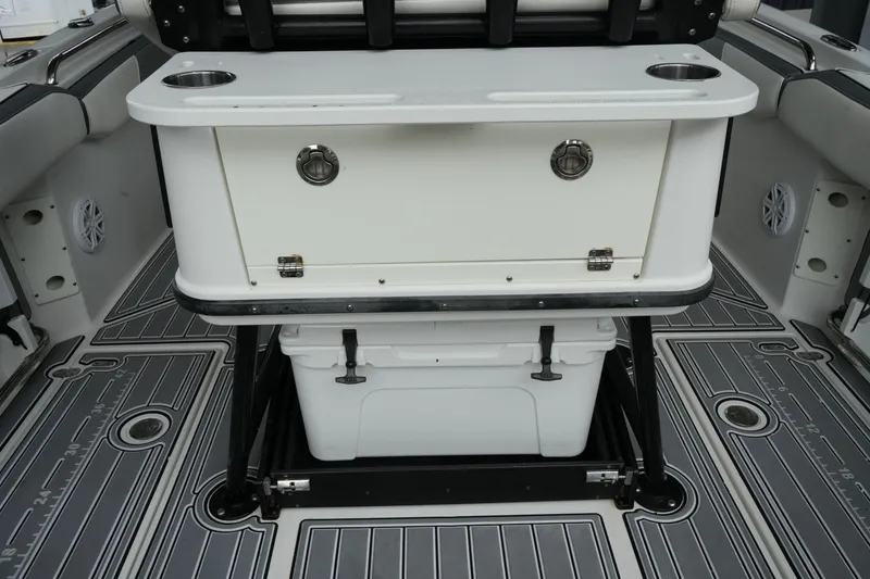 Slide: The Image of 2019 Blackfin 242 CC boat interior with storage and seating area. - 13