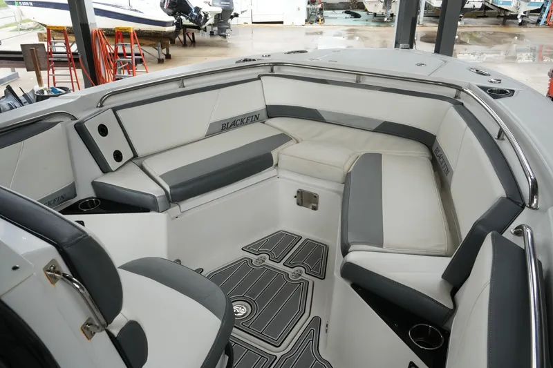 Slide: The Image of 2019 Blackfin 242 CC boat interior with cushioned seating and sleek design. - 18